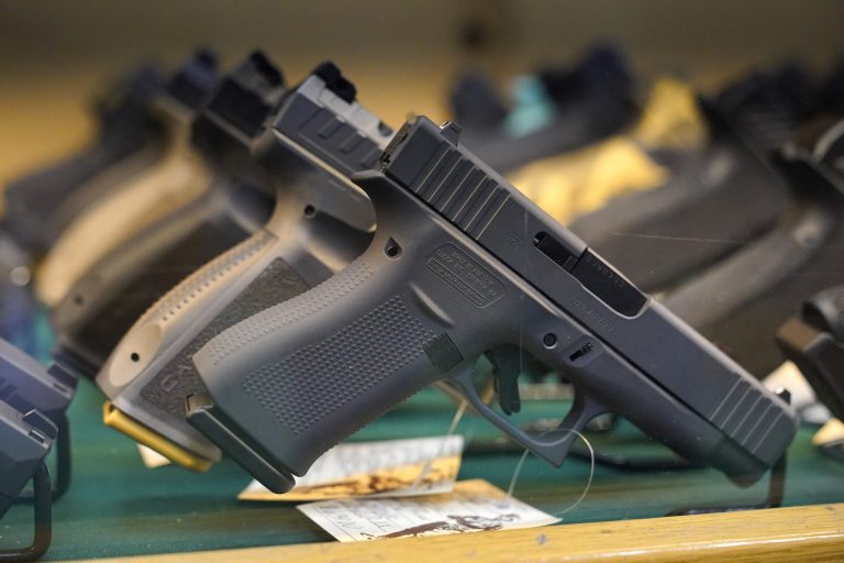 FILE - Handguns are displayed at a pawn shop Monday, July 18, 2022, in Auburn, Maine. (AP Photo/Robert F. Bukaty, File)