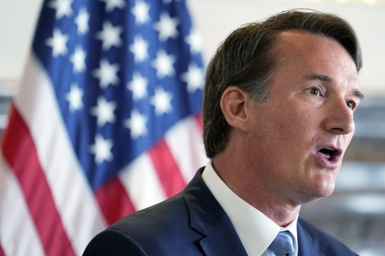 Virginia Governor Glenn Youngkin accompanied by U.S. Ambassador to Japan Rahm Emanuel and Micron Executive Vice President Manish Bhatia, both not in picture, speaks during a news conference about U.S.-Japan cooperation on economic issues, including the semiconductor supply chain Thursday, April 27, 2023, in Tokyo. (AP Photo/Eugene Hoshiko)