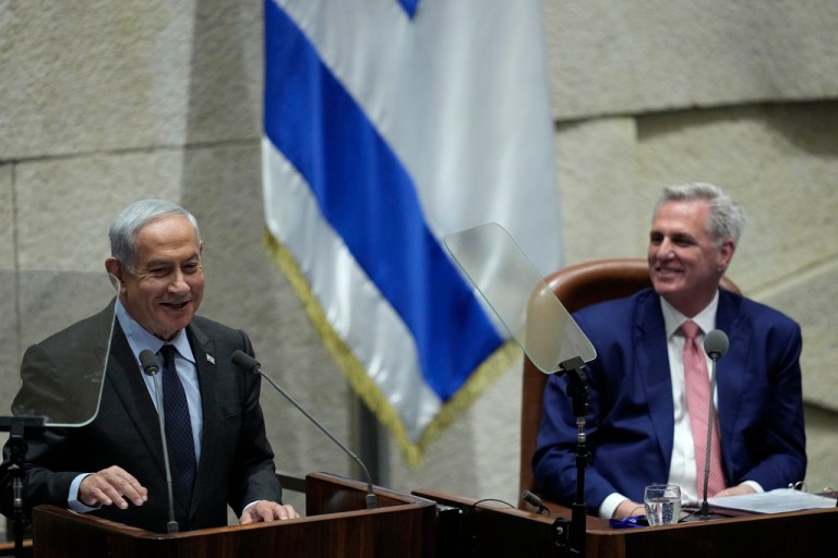 Israeli Prime Minister Benjamin Netanyahu, left, speaks as U.S. Speaker of the House Kevin McCarthy, right, reacts during a session of the Knesset, Israel's parliament in Jerusalem, Monday, May 1, 2023. 