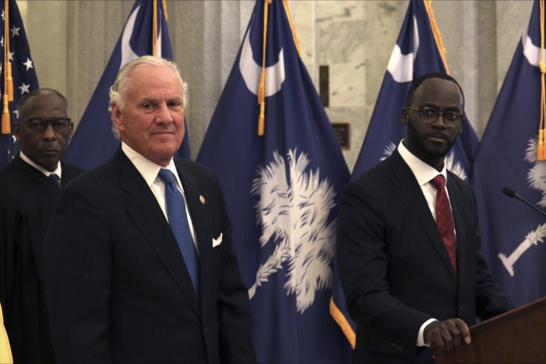 South Carolina Supreme Court Chief Justice Donald Beatty, Gov. Henry McMaster and new Comptroller General Brian Gaines at a news conference Friday, May 12, 2023, in Columbia, S.C.