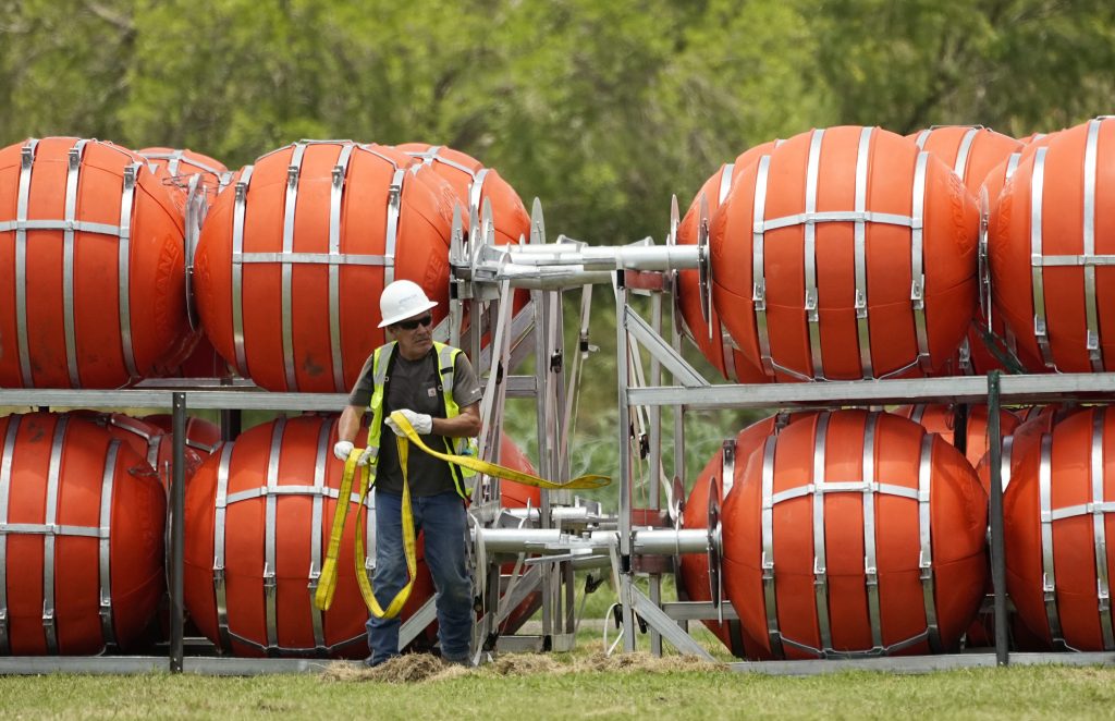 Dozens of large buoys that are set to be deployed in the Rio Grande are unloaded, Friday, July 7, 2023, in Eagle Pass, Texas, where border crossings continue to place stress on local resources.