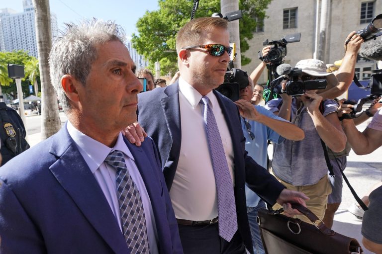 Carlos De Oliveira, left, an employee of Donald Trump's Mar-a-Lago estate, arrives for a court appearance with attorney John Irving, at the James Lawrence King Federal Justice Building, Monday, July 31, 2023, in Miami. 