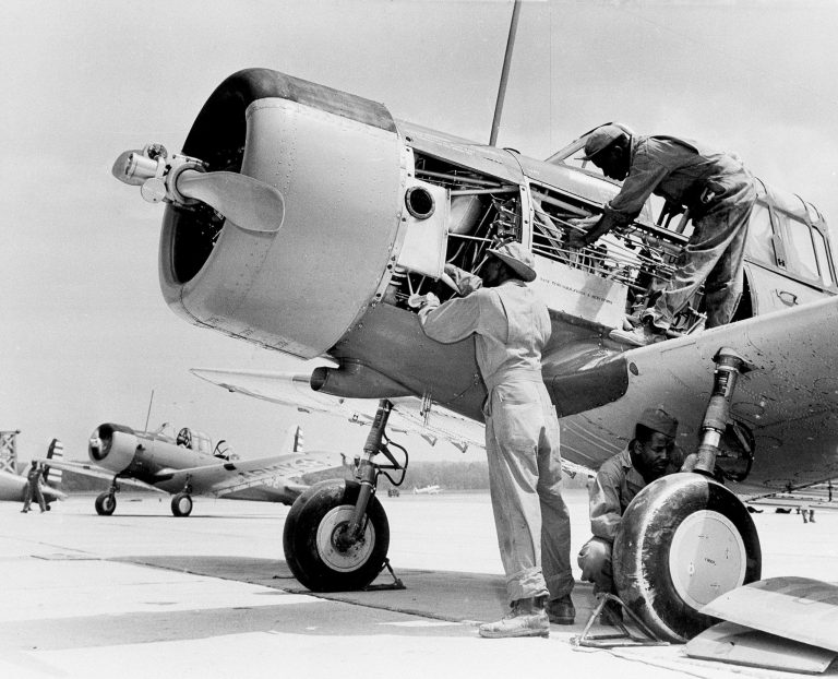 African-American airplane mechanics of the 99th Pursuit Squadron inspect the engine of a  BT-13 Valiant trainer aircraft at the new U.S. Army Flying School in Tuskegee, Ala., Sept. 5, 1942.