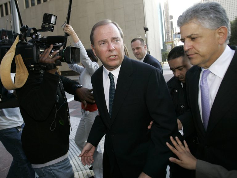 FILE - In this Oct. 23, 2006, file photo former Enron CEO Jeff Skilling, left, leaves the federal courthouse with his attorney Daniel Petrocelli, right, after being sentenced to 292 months in federal prison. Federal prosecutors and attorneys for Skilling say they have reached an agreement that will reduce the jailed executive's sentence for his role in the energy giant's collapse. Under the agreement, Skilling's original sentence will be reduced to somewhere between 14 and 17.5 years. (AP Photo/David J. Phillip, File)