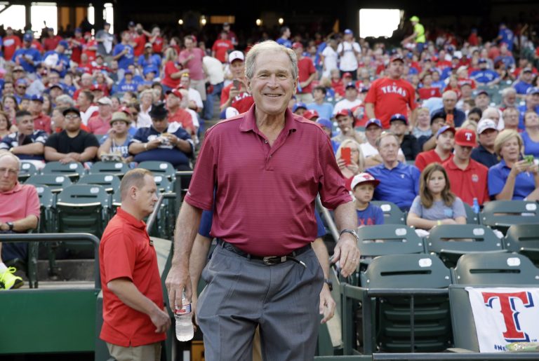 Former President George W. Bush arrives before Game 3 of baseball's American League Division Series between the Texas Rangers and the Toronto Blue Jays, Sunday, Oct. 11, 2015, in Arlington, Texas. (AP Photo/LM Otero)