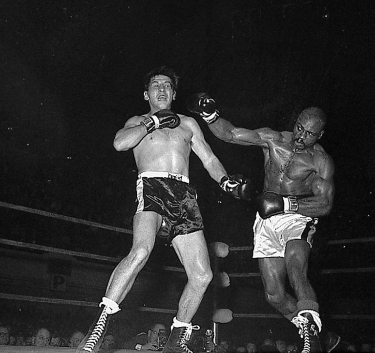 Joey Giardello, left defending his middleweight crown, takes a punch from Rubin 