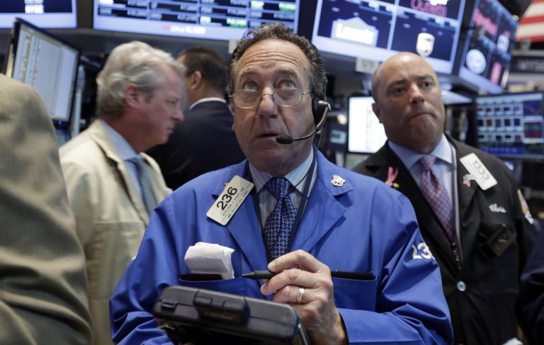 Trader Steven Kaplan, center, works on the floor of the New York Stock Exchange, Monday, Aug. 4, 2014. U.S. stocks are opening mostly higher as the market recovers from a two-day slide last week. (AP Photo/Richard Drew)