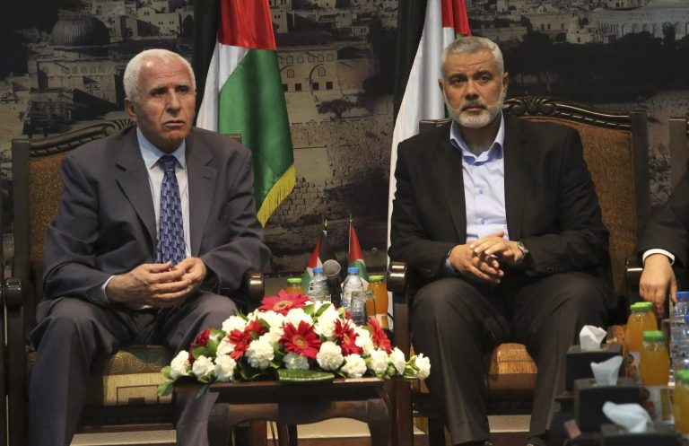 Gaza's Hamas Prime Minister Ismail Haniyeh, right, and senior Fatah official Azzam al-Ahmad meet in Gaza for talks aimed at reaching a reconciliation agreement between the two rival Palestinian groups, Hamas and Fatah on Tuesday, April 22, 2014. Palestinians have been divided since 2007 when Hamas took control of the Gaza Strip from Fatah forces loyal to Palestinian President Mahmoud Abbas. (AP Photo/Hatem Moussa)