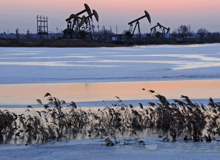   In this Friday March 16, 2012 photo, made available March 26, 2012, oil rigs belonging to PetroChina are seen near the banks of a snow covered lake in Daqing in northeastern China's Heilongjiang province. The price of oil rose slightly Monday Dec. 3, 2012, as a strong manufacturing report from China countered a weak one in the U.S. An index measuring manufacturing in China showed expansion in November for the first time in 13 months. China is the world's second-largest economy and a huge consumer of oil. A better economy there suggests that energy consumption is likely to grow, pushing oil prices higher. (AP Photo) CHINA OUT  