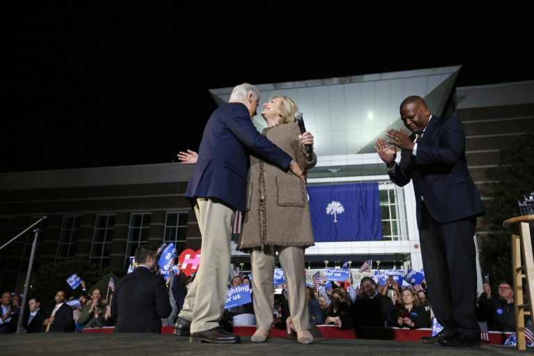 Democratic presidential candidate Hillary Clinton and her husband, former President Bill Clinton, hug as they arrive to speak at a 