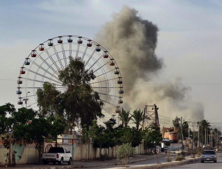 A plume of smoke rises after an airstrike by the U.S.-led coalition against Islamic State group positions in an eastern neighborhood of Ramadi, Iraq. (AP Photo)