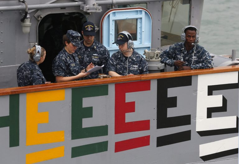 U.S. navy personnel of the USS Antietam (CG-54) from the George Washington Battle Group chat before sailing to the Philippines at Hong Kong Victoria Harbor Tuesday, Nov. 12, 2013. The United States has pledged $20 million in immediate aid and has ordered the aircraft carrier USS George Washington to the sail to the Philippines to provide assistance in the wake of the typhoon. (AP Photo/Kin Cheung)