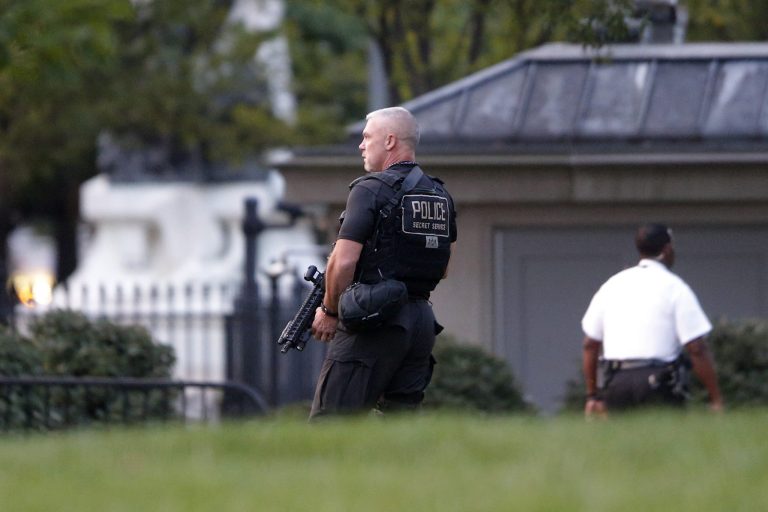 A member of the U.S. Secret Service Emergency Response Team (ERT) stands watch on the North Lawn at the White House in Washington, Aug. 7, 2014. A brief security alert ensued when a child slipped through the gates of the White House, according to Secret Service officials. (AP Photo/Charles Dharapak)