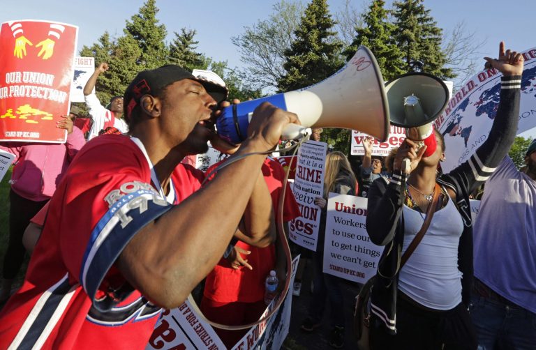 Protesters gather outside of the McDonald's Corporation headquarters in Oak Brook, Ill., the annual shareholders meeting demonstrating for higher wages and the right to unionize, in this May 22, 2014 file photo. (AP Photo/M. Spencer Green, File)