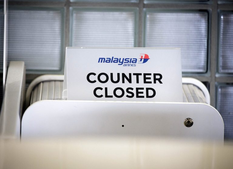 A closed desk of Malaysian airlines is seen at Schiphol airport in Amsterdam, Thursday, July 17, 2014. Ukraine said a passenger plane carrying 295 people was shot down Thursday as it flew over the country, and both the government and the pro-Russia separatists fighting in the region denied any responsibility for downing the plane. (AP Photo/Phil Nijhuis)