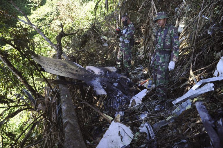   FILE- In this Saturday, May 12, 2012 file photo, Indonesian marines inspect the wreckage of a Sukhoi Superjet-100 that crashed on the mountainside in Bogor, West Java, Indonesia. Human error caused a Russian-made passenger jetliner to crash into an Indonesia volcano seven months ago during a demonstration flight, killing all 45 people aboard, the National Commission on Safety Transportation announced Tuesday, Dec. 18, 2012. (AP Photo/File)  