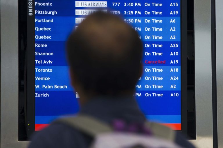 A traveler views a departures board Tuesday, July 22, 2014, at the Philadelphia International Airport in Philadelphia. The Federal Aviation Administration is telling U.S. airlines they are prohibited from flying to the Tel Aviv airport in Israel for 24 hours after a Hamas rocket exploded nearby. (AP Photo/Matt Rourke)