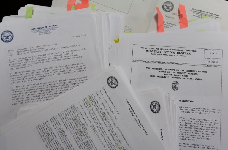 Documents obtained following Freedom of Information Act requests filed with the Army, Navy, Air Force, Marines and Naval Criminal Investigative Service, are displayed at the AP office in Tokyo on Jan. 29. (AP Photo/Shizuo Kambayashi)