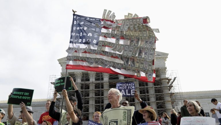 In this 2013 photo, demonstrators gather outside the U.S. Supreme Court as the court heard arguments on campaign finance. To advocates of campaign finance restrictions like former Sen. Russ Feingold, using money to express political views makes politics more corrupt and extreme. But more regulation is a surefire way to get less speech - just not from the rich and powerful. (AP Photo/Susan Walsh)