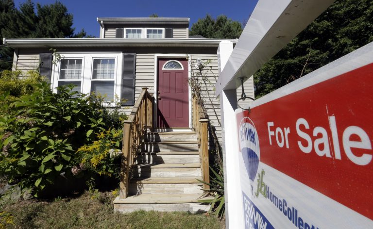 FILE - In this Wednesday, Sept. 18, 2013 file photo a for sale sign hangs in front of a house in Walpole, Mass.  Freddie Mac reports on mortgage rates for this week Thursday April 14, 2014.  (AP Photo/Steven Senne, File)