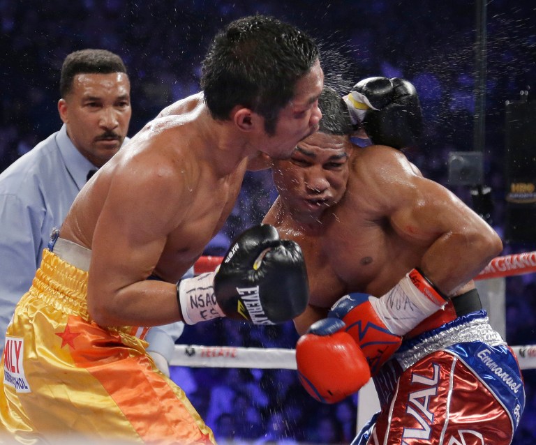   Yuriorkis Gamboa, from Miami, Fla., right, and Michael Farenas, from the Philippines, trade blows in close as referee Tony Weeks looks on during their WBA interim super featherweight title fight Saturday, Dec. 8, 2012, in Las Vegas. (AP Photo/Julie Jacobson)  