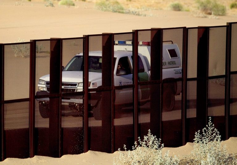 A U.S. border patrol vehicle drives along the U.S.-Mexico border fence near Yuma, Ariz., as seen from the outskirts of San Luis Rio Colorado, Mexico. (AP/Guillermo Arias)
