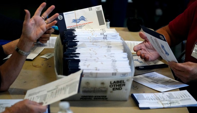 Chester County, Pa. election workers process mail-in and absentee ballots for the 2020 general election in the United States at West Chester University, Wednesday, Nov. 4, 2020, in West Chester.