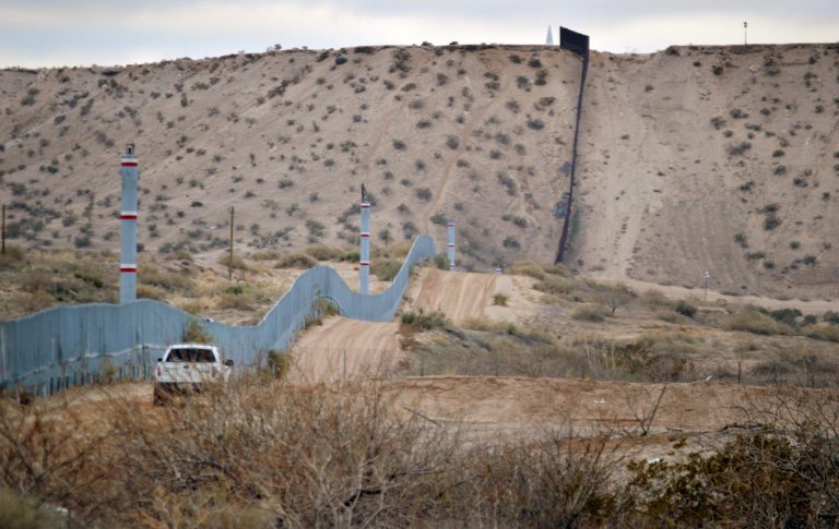 A U.S. Border Patrol agent drives near the U.S.-Mexico border fence in Sunland Park, N.M. (AP Photo/Russell Contreras)