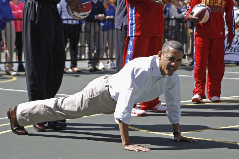 President Obama does pushups during the annual Easter Egg Roll on the White House tennis court April 9, 2012. (Getty images File)