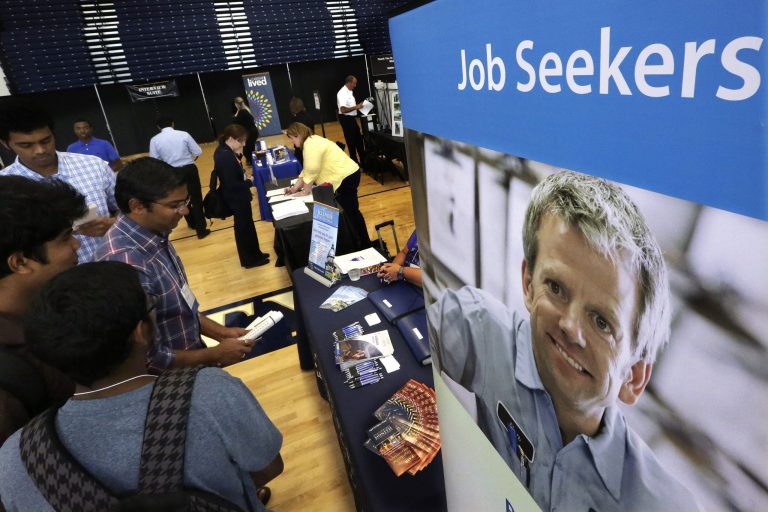 In this Sept. 25, 2014 photo, students attend The Foot in the Door Career Fair at the University of Illinois in Springfield, Ill. The Labor Department releases employment data for September on Friday, Oct. 3, 2014. (AP Photo/Seth Perlman)