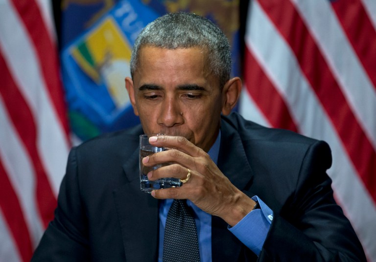 President drank some filtered water after meeting with officials Wednesday. (AP Photo/Carolyn Kaster)