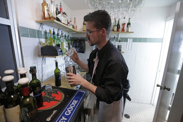 FILE - In this Feb. 26, 2013, file photo, manager Dustin Humes fixes a drink in a small room which is out of the view of patrons at Vivace Restaurant, in Salt Lake City. The Mormon church has issued a sweeping defense of Utah's famously strict liquor laws, drawing a line against tourism, restaurant and bar industry advocates who have helped ease alcohol regulations in recent years. Ahead of the upcoming legislative session, The Church of Jesus Christ of Latter-day Saints posted to its website a hefty multimedia policy statement urging lawmakers to uphold rules that church leaders say are 