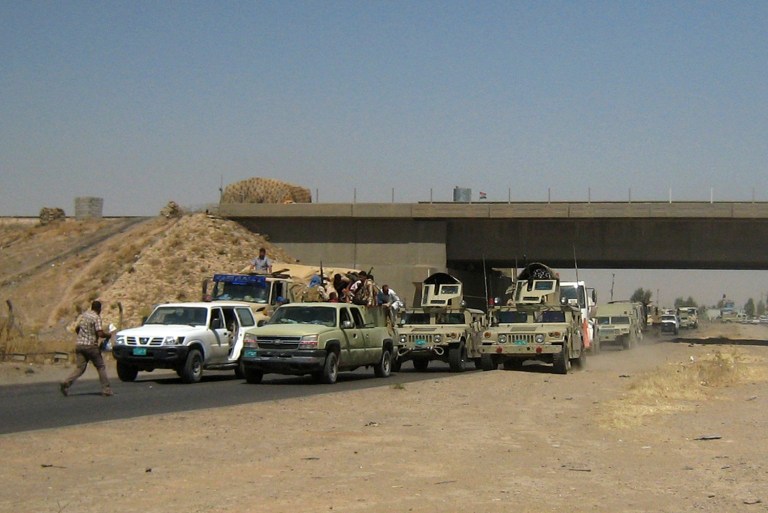 Iraqi security forces in uniforms and plainclothes head to Baghdad in the main road between Baghdad and Mosul, a day after fighters from the Islamic State of Iraq and the Levant took control of much of Mosul. Al Qaeda-inspired militants seized effective control Wednesday of Saddam Hussein's hometown of Tikrit, expanding their offensive closer to the Iraqi capital as soldiers and security forces abandoned their posts following clashes with the insurgents. (AP Photo)