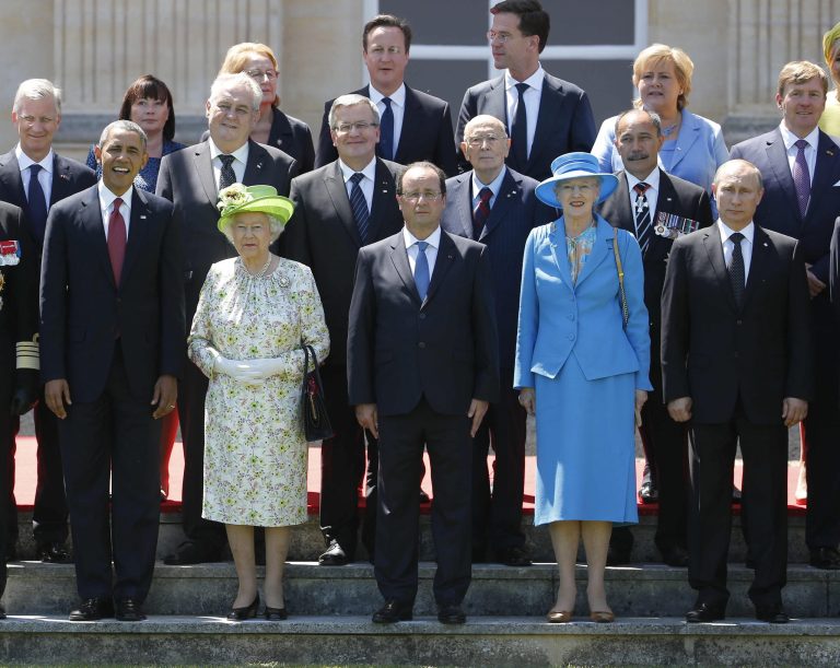 U.S. President Obama, front left, and French President Francois Hollande, front center, stand with Britain's Queen Elizabeth II, second left, and Russian President Vladimir Putin, front right, and other leaders, stand for a group photo as they take part in the 70th anniversary of D-Day in Benouville in Normandy, France, Friday. (AP Photo/Charles Dharapak)