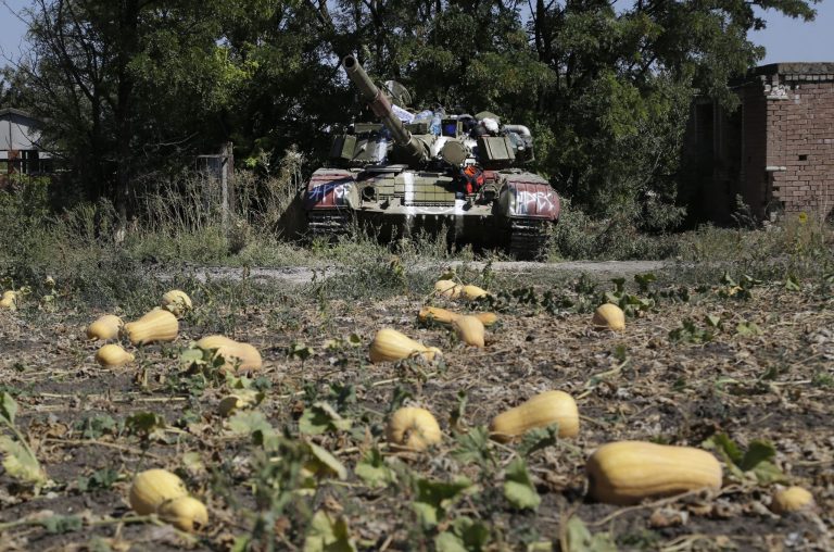 An abandoned Ukrainian army tank is seen in the village of Kominternove , Ukraine, Saturday, Sept. 6, 2014. After four months of war, eastern Ukraine begins the first full day of an uncertain cease-fire. The truce agreement calls for an exchange of prisoners and establishment of humanitarian corridors, but how quickly those actions will begin is unclear. (AP Photo/Sergei Grits)