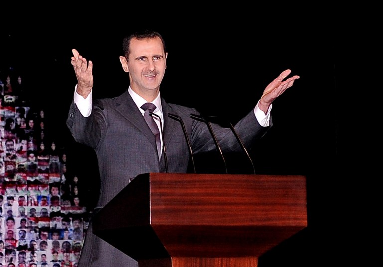 FILE - In this Sunday, Jan. 6, 2013 file photo released by the Syrian official news agency SANA, Syrian President Bashar Assad gestures speaks at the Opera House in central Damascus, Syria. Assad has warned that the fall of his regime or the breakup of Syria will unleash a wave of instability that will shake the Middle East for years to come. Assad told the Turkish TV station Ulusal Kanal in an interview aired Friday, April 5, 2013 that 