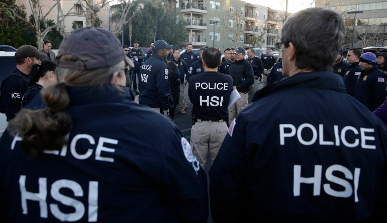 Federal agents gather at a parking lot near an upscale apartment complex, Tuesday, March 3, 2015, in Irvine, Calif. Shortly after sunrise, federal agents swarmed the complex in the Orange County where authorities say a birth tourism business charged pregnant women $50,000 for lodging, food and transportation. The key draw for travelers is that the United States offers birthright citizenship. 