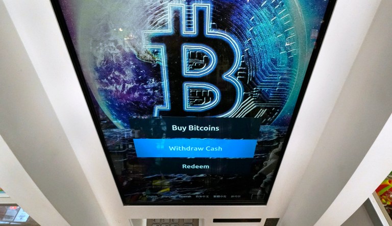 The Bitcoin logo appears on the display screen of a crypto currency ATM at the Smokerâs Choice store, Tuesday, Feb. 9, 2021, in Salem, N.H.  The price of Bitcoin has soared over the past months. (AP Photo/Charles Krupa) 