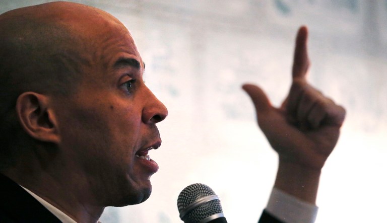 Democratic presidential candidate Sen. Cory Booker, D-N.J., gestures as he addresses guests at a house party during a campaign stop in Claremont, N.H., Friday, March 15, 2019.