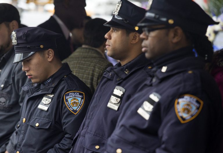NYPD officers stand just after a moment of silence. (AP Photo/Craig Ruttle)