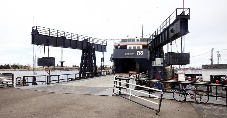 In a Thursday, April 30, 2014 photo, Lake Michigan Carferry SS Badger Capt. Jeff Curtis exits the 410-foot boat, in Ludington, Mich. When the SS Badger sets sail May 16, the venerable and historic carferry will sport new combustion controls that will enable it to burn coal more efficiently. That should result in less coal being burned and less ash being produced by the Badger.  (AP Photo/Ludington Daily News, Jeff Kiessel) MANDATORY CREDIT