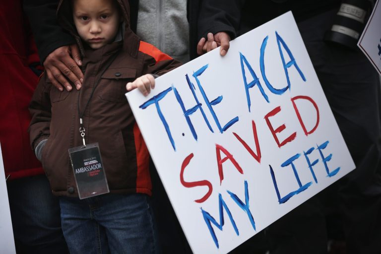 Five-year-old James Cook of Cleveland, Ohio, participates in a rally to support the Affordable Care Act in front of the U.S Supreme Court March 4, 2015 in Washington, DC. (Photo by Alex Wong/Getty Images)
