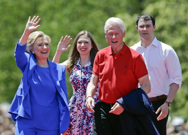 Democratic presidential candidate former Secretary of State Hillary Rodham Clinton waves to supporters as her husband former President Bill Clinton, second from right, Chelsea Clinton, second from left, and her husband Marc Mezvinsky, join on stage Saturday, June 13, 2015, on Roosevelt Island in New York. Mezvinsky is part of a hedge fund with links to the Cayman Islands. (AP Photo/Frank Franklin II)