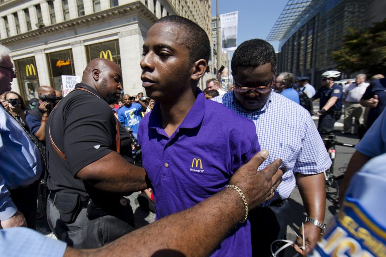 A McDonald's worker is detained by police during a protest to push fast-food chains to pay their employees at least $15 an hour, outside a McDonald's restaurant Thursday, Sept. 4, 2014, in Philadelphia. The protest movement, which is backed financially by the Service Employees International Union and others, has gained national attention at a time when the wage gap between the poor and the rich has become a hot political issue. (AP Photo/Matt Rourke)