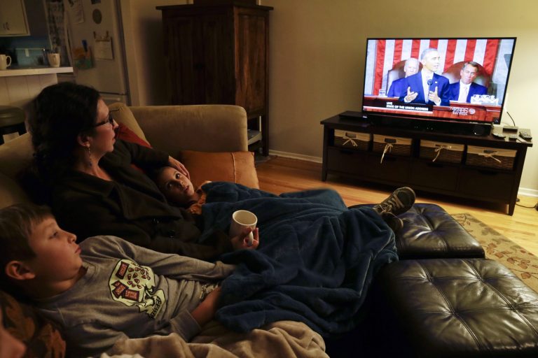 Diana Meza-Ehlert watches as President Obama delivers his State of the Union address Tuesday. (AP/Gregory Bull)