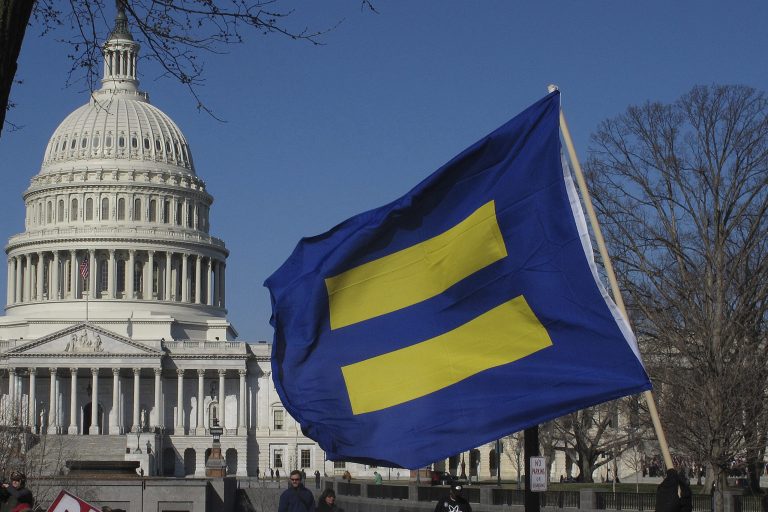 Demonstrators hold signs and line the sidewalks in front of the Capitol Building and the Supreme Court in Washington D.C. on March 26. (AP/Alex Menendez)