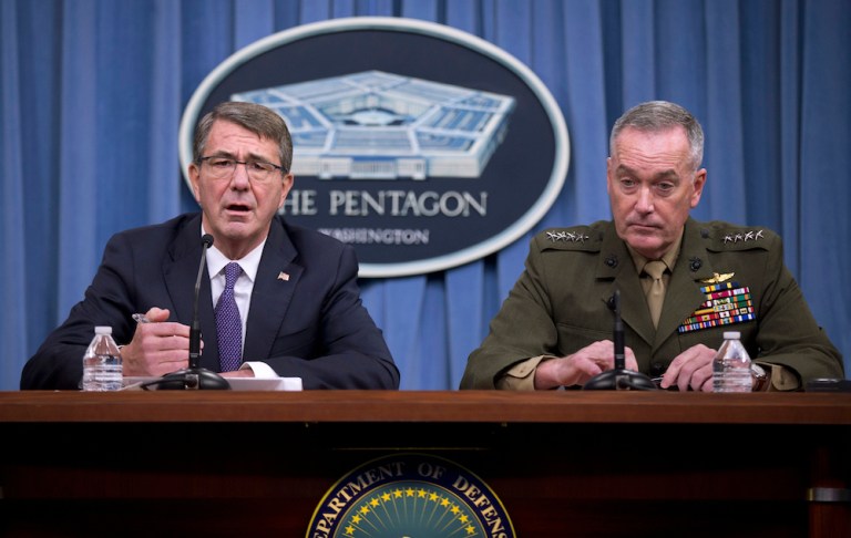 The new award is a bronze disc with a dagger and scorpion being held by a mailed hand. (AP Photo/Mauel Balce Ceneta)