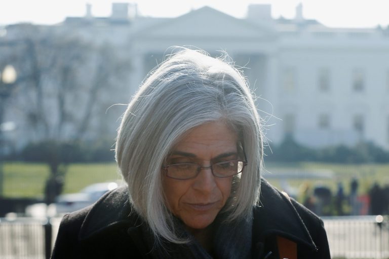 Judy Gross, wife of Alan Gross, walks as she is interviewed before an event to mark his fourth year in prison in Cuba, Tuesday, Dec. 3, 2013, in Lafayette Park across from the White House in Washington. Gross, working as a subcontractor for the U.S. government's U.S. Agency for International Development (USAID), was arrested while working covertly in the communist-run country as a subcontractor for the U.S. government's U.S. Agency for International Development to set up Internet access for the Cuba's small Jewish community, access that bypassed local restrictions.(AP Photo/Charles Dharapak)