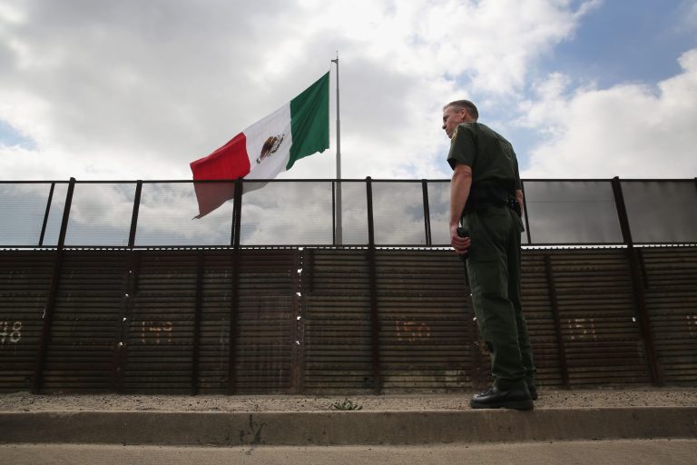 U.S. Border Patrol agent Jerry Conlin stands on the American side of the U.S.-Mexico border fence on October 3, 2013 at San Ysidro, Calif.  (Photo by John Moore/Getty Images)
