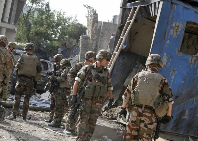 Foreign troops, part of the NATO-led International Security Assistance Force, investigate the site a day after an assault on an international compound in Kabul, Afghanistan. (AP/Ahmad Jamshid)